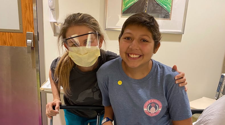Amelia Ballard, a registered nurse at Children's Healthcare of Atlanta, and a cancer survivor, always knew she wanted to work in pediatric oncology. Here she is with Dani Cuevas, who is 15. (Courtesy of Children’s Healthcare of Atlanta)