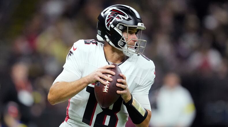 Atlanta Falcons quarterback Kirk Cousins drops back to pass against the New Orleans Saints in the first half of an NFL football game, Sunday, Nov. 23, 2025, in New Orleans. (AP Photo/Gerald Herbert)