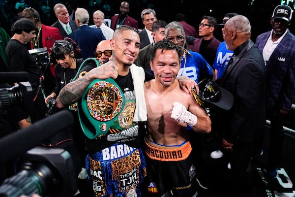 Mario Barrios, left, and Manny Pacquiao one for a photo after fighting to a majority draw in a welterweight title boxing match Saturday, July 19, 2025, in Las Vegas. (AP Photo/John Locher)