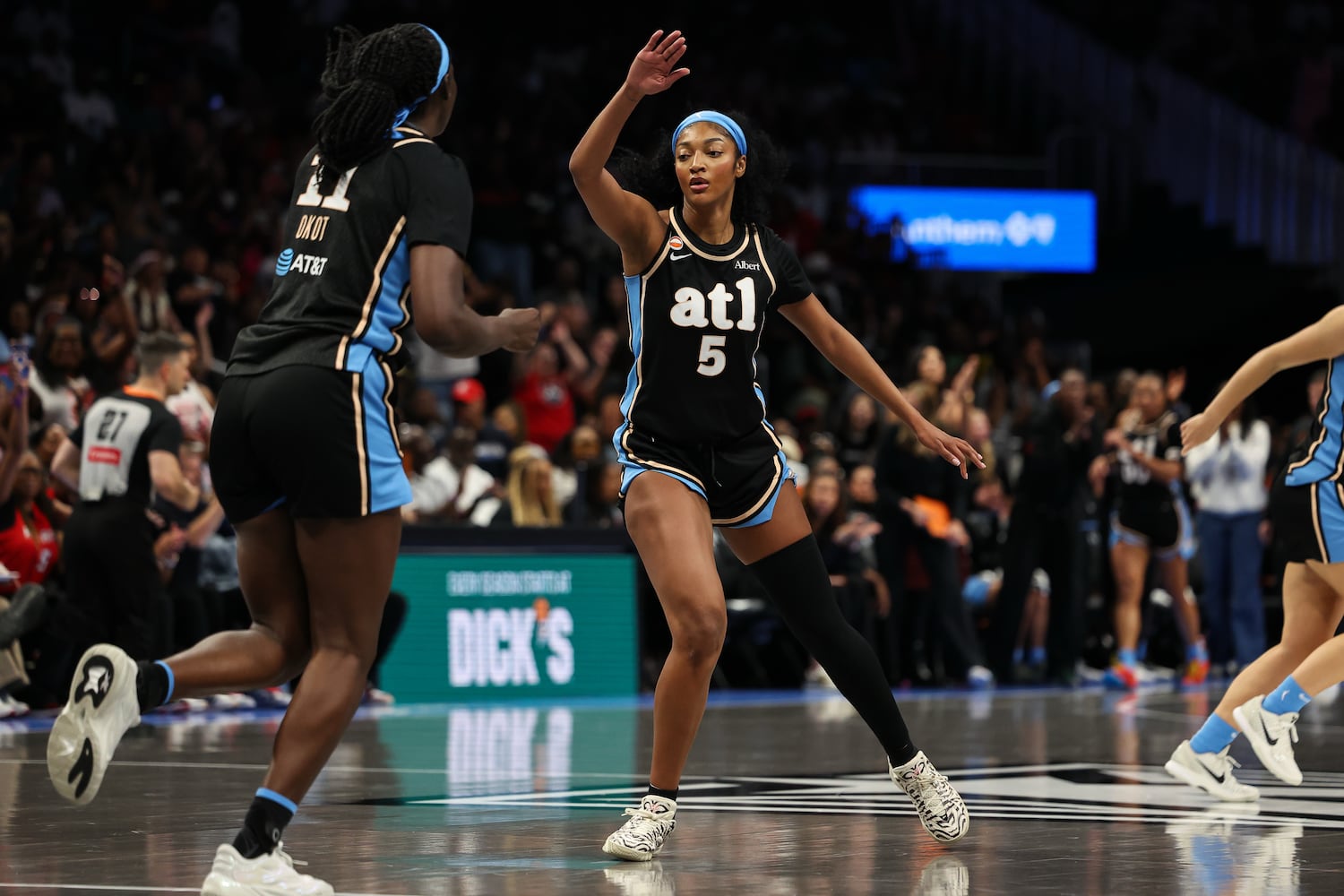 Dream forward Angel Reese (center) reacts with center Madina Okot during the first half Sunday, May 17, 2026, at State Farm Arena in Atlanta. (Colin Hubbard for the AJC) 
