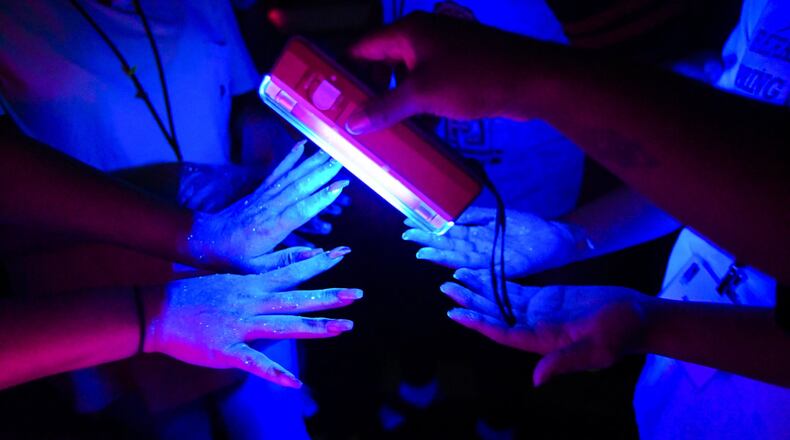 Students have their hands examined to see how effectively they washed them during summer camp at Philadelphia College of Osteopathic Medicine. Georgia’s Opportunities Academy gives Gwinnett high school students interested in future health care careers a chance to learn more about various professions. John Amis/ for the AJC