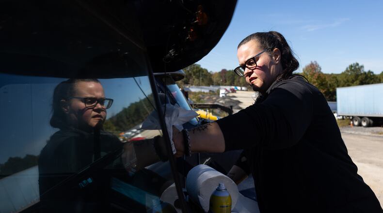 Jessica Graham applies Rain-X to the windshield of her truck in Lithonia. (Elijah Nouvelage for The Atlanta Journal-Constitution)