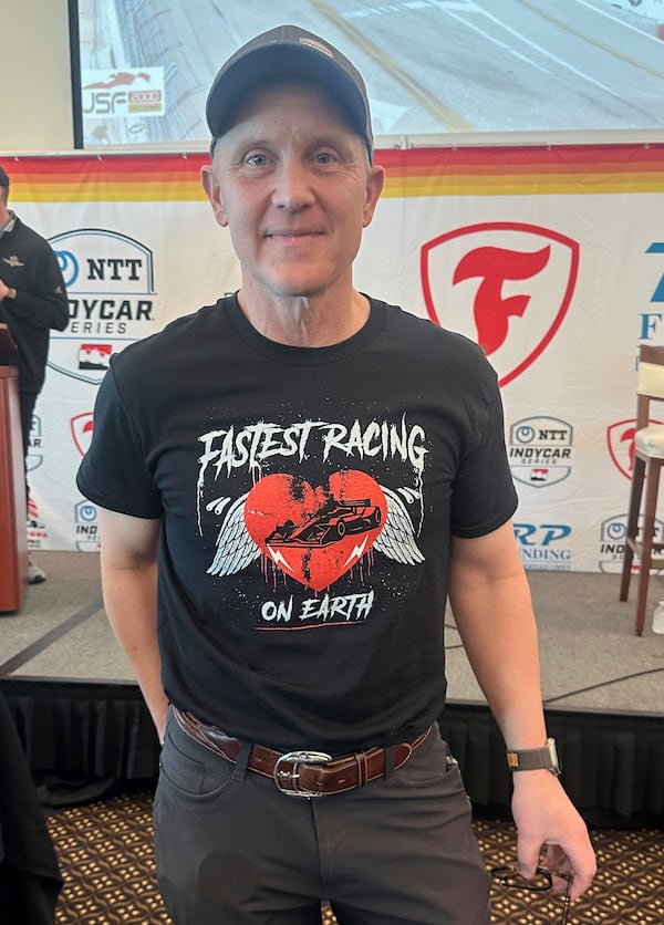 FOX Sports CEO & Executive Producer Eric Shanks poses in a T-shirt he designed to promote the IndyCar auto racing season on March 4, 2025, in St. Petersburg, Fla. (AP Photo/Jenna Fryer)