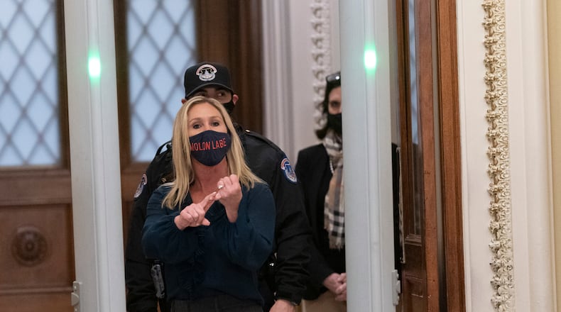 Rep. Marjorie Taylor Greene, R-Ga., yells at journalists as she passes through a newly installed metal detector outside the House Chamber on Jan 12, 2021. (Chris Kleponis/Sipa USA/TNS)