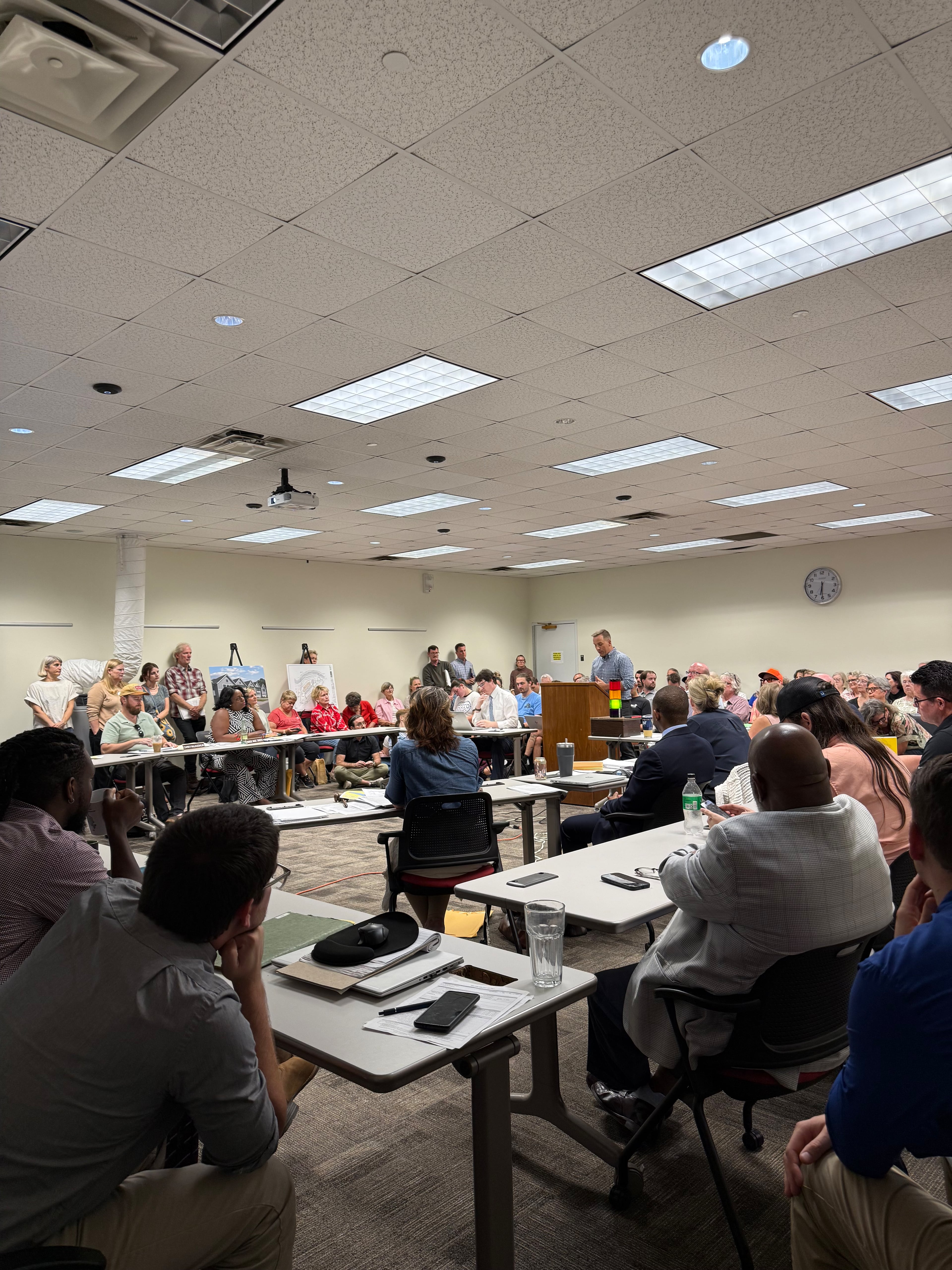 Athens residents packed an Athens-Clarke County Planning Commission meeting on Thursday, Sept. 4, 2025 to discuss a proposed hotel. Parker Henderson of Hilton's Graduate division of hotels is at the podium. (Rebecca McCarthy for the AJC)