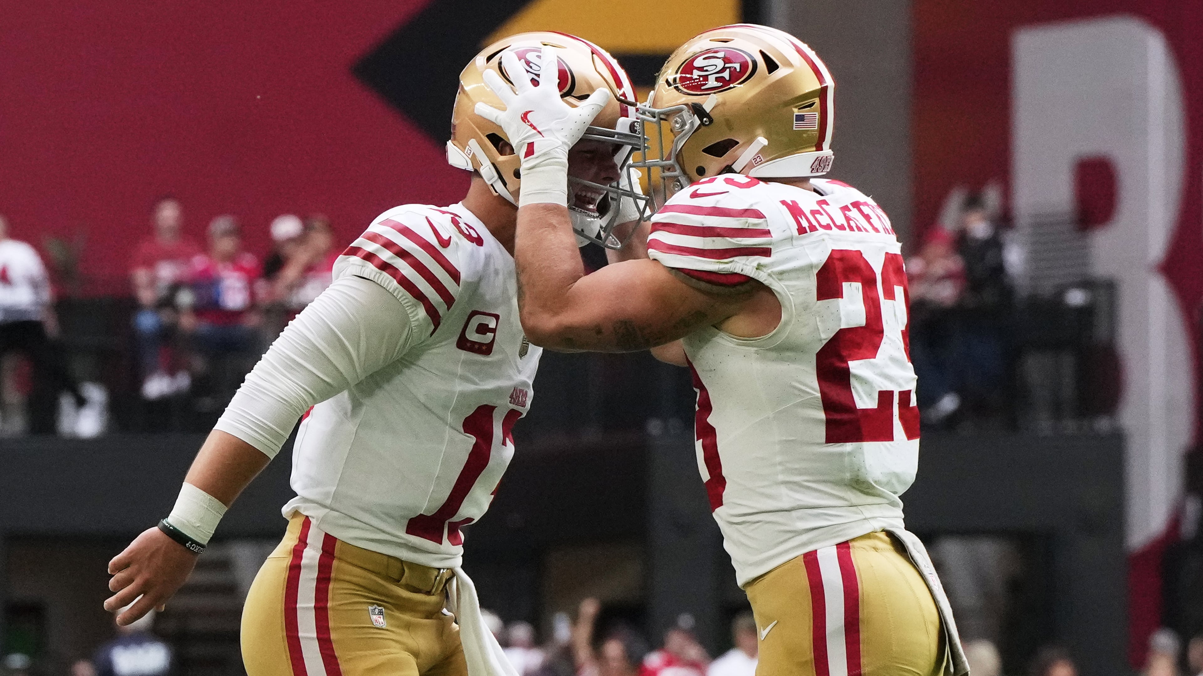 San Francisco 49ers quarterback Brock Purdy, left, and running back Christian McCaffrey celebrate after connecting on a touchdown pass against the Arizona Cardinals during the first half of an NFL football game in Glendale, Ariz., Sunday, Nov. 16, 2025. (AP Photo/Rick Scuteri)