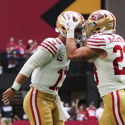 San Francisco 49ers quarterback Brock Purdy, left, and running back Christian McCaffrey celebrate after connecting on a touchdown pass against the Arizona Cardinals during the first half of an NFL football game in Glendale, Ariz., Sunday, Nov. 16, 2025. (AP Photo/Rick Scuteri)