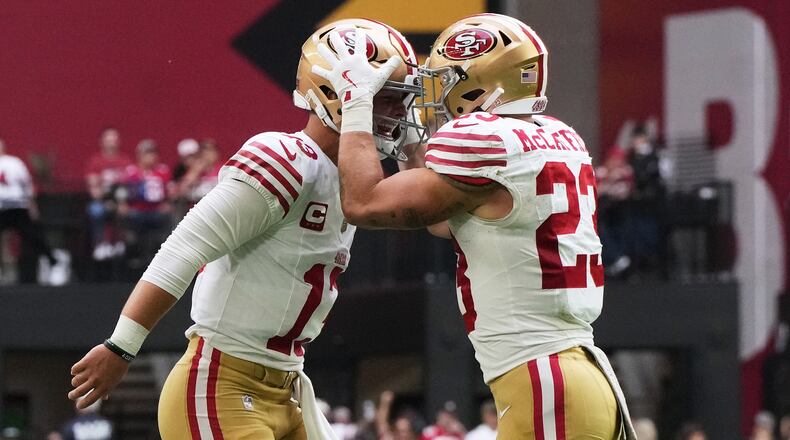 San Francisco 49ers quarterback Brock Purdy, left, and running back Christian McCaffrey celebrate after connecting on a touchdown pass against the Arizona Cardinals during the first half of an NFL football game in Glendale, Ariz., Sunday, Nov. 16, 2025. (AP Photo/Rick Scuteri)