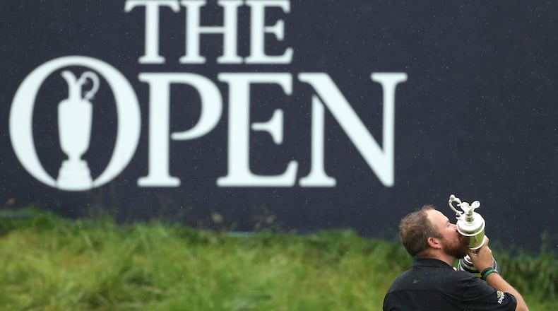 Ireland's Shane Lowry holds and kisses the Claret Jug trophy on the 18th green as he poses for the crowd and media after winning the 2019 British Open Golf Championships at Royal Portrush in Northern Ireland.