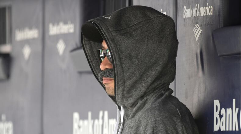 Ichiro Suzuki, special assistant to the chairman of the Seattle Mariners, wears a fake mustache and a hoodie as he sits in the dugout and watches the New York Yankees bat during the first inning of Thursday's baseball game.