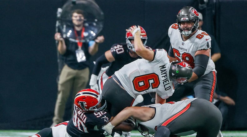 Atlanta Falcons defensive tackle David Onyemata (90) sacks Tampa Bay Buccaneers quarterback Baker Mayfield (6) during the second half of an NFL football game on Thursday, October 3, 2024, at Mercedes-Benz Stadium in Atlanta. 
(Miguel Martinez/ AJC)