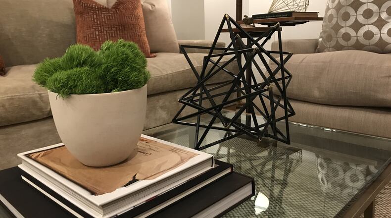 A simple ecru vessel filled with wild grasses serves as en elegant arrangement for small surfaces. (Design Recipes)