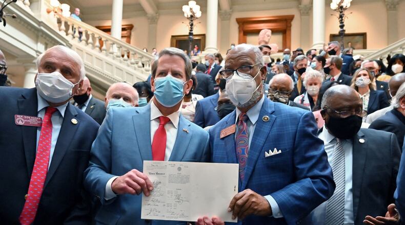 June 26, 2020 Atlanta - Gov. Brian Kemp and Rep. Calvin Smyre hold the signed HB 426, hate-crimes legislation, on the last day of the legislative session at Georgia State Capitol on Friday, June 26, 2020.. (Hyosub Shin / Hyosub.Shin@ajc.com)