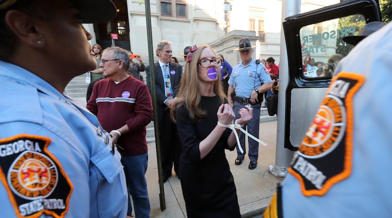 October 27, 2014 Atlanta: Kathy Acker was one of eight people arrested Monday evening October 27, 2014 when they refused to leave the Secretary of State's office at the State Capitol while protesting because they say 40,000 voters registered, but haven't been added to the voter rolls. BEN GRAY / BGRAY@AJC.COM Kathy Acker was one of eight people arrested Monday evening when they refused to leave the office of Secretary of State Brian Kemp at the State Capitol while protesting “lost” registered voters. A Fulton County judge declined to intervene in the matter on Tuesday. Ben Gray, bgray@ajc.com