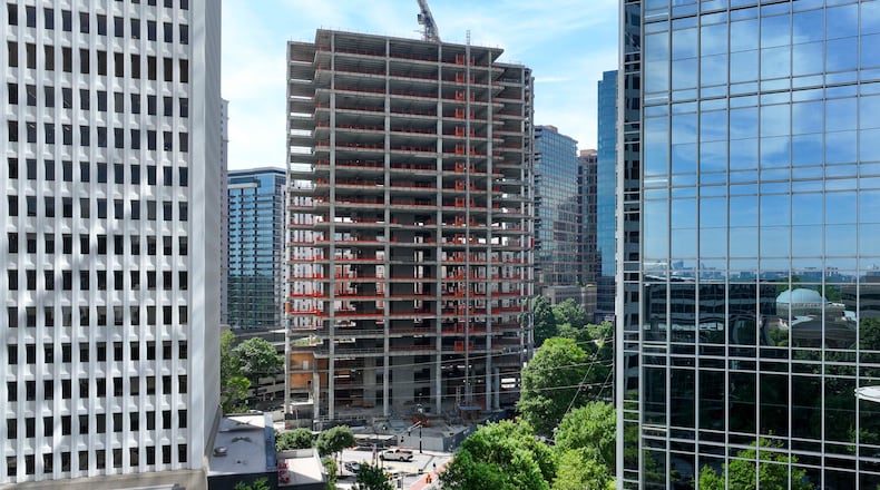An aerial photo from May 2026 shows the Campanile building at the corner of Peachtree and 14th Streets in Midtown Atlanta . The well-known construction site, which its owner has renamed The Midtowne, has remained unfinished for years. (Miguel Martinez/AJC)