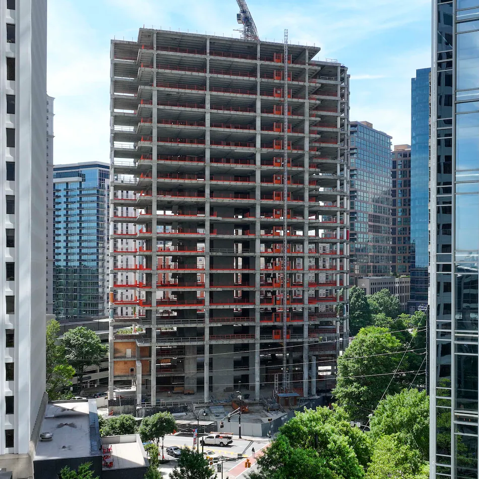 An aerial photo from May 2026 shows the Campanile building at the corner of Peachtree and 14th Streets in Midtown Atlanta . The well-known construction site, which its owner has renamed The Midtowne, has remained unfinished for years. (Miguel Martinez/AJC)