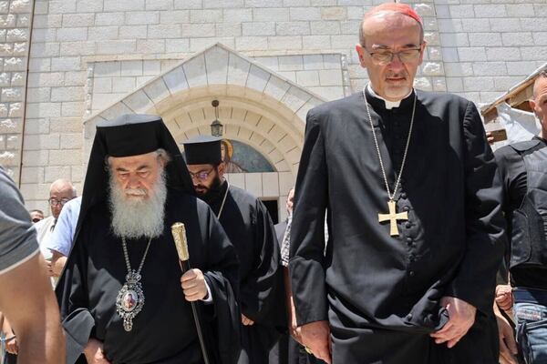 Patriarchs from Jerusalem, Greek Orthodox Patriarch Theophilos III, left, and Latin Patriarch Cardinal Pierbattista Pizzaballa, right, lead a religious delegation to the Gaza Strip at the Holy Family Catholic Church, struck by an Israeli shell the day before in Deir al-Balah, Friday, July 18, 2025. (Latin Patriarchate of Jerusalem via AP)