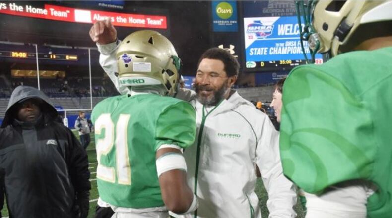 Buford coach Bryant Appling celebrates with Jalen Huff after beating Warner Robins