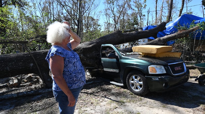 Kathy Hauner stands outside her mobile home in Montgomery County that was severely damaged by Hurricane Helene on Monday, Oct. 21, 2024. (Hyosub Shin/AJC)