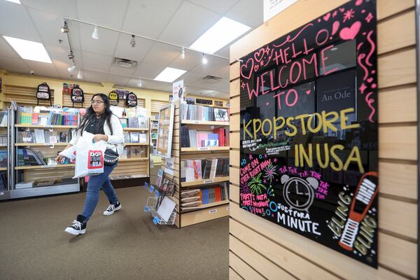 K-pop fan Cruz Segura of Hapeville leaves after shopping at the KPOP Store in USA in Doraville. (Jason Getz / Jason.Getz@ajc.com)