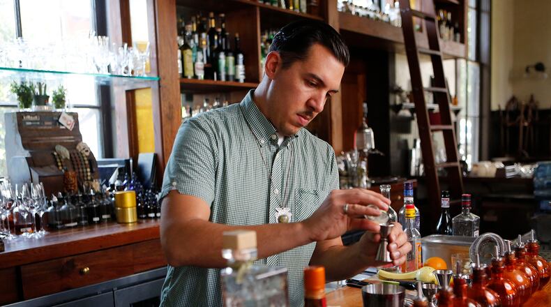 Miles Macquarrie mixes classic cocktails at the Kimball House in Decatur. / AJC file photo