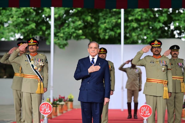In this photo released by the Prime Minister Office, Pakistan's Prime Minister Shehbaz Sharif, center, and Army Chief General Asim Munir, left, attend a passing out ceremony of army officers at the Pakistan Military Academy Kakul, in Abbottabad, Pakistan, Saturday, April 26, 2025. (Prime Minister Office via AP)