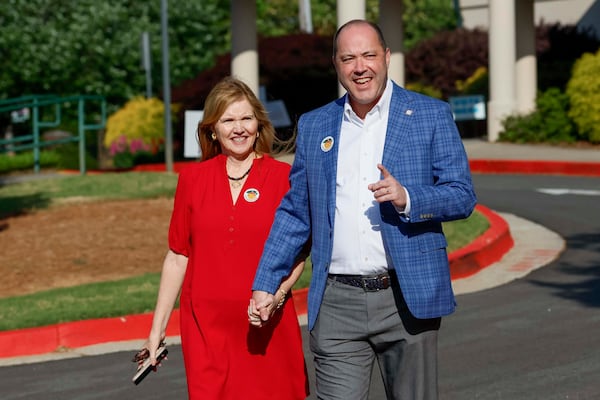 Georgia Attorney General Chris Carr and his wife, Joan, cast their votes on the first day of early voting for Georgia's primary elections. (Miguel Martinez/AJC)