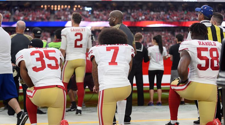 Eric Reid and Colin Kaepernick kneel during the national anthem before a game during the 2016 season.