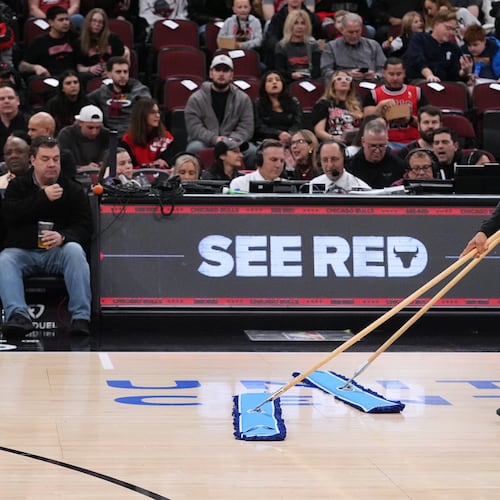 United center employees clean the court during a delay before an NBA basketball game against the Miami Heat in Chicago, Thursday, Jan. 8, 2026. (AP Photo/Nam Y. Huh)