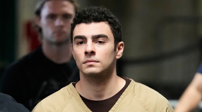 FILE - Luigi Mangione is escorted into Manhattan state court in New York, Sept. 16, 2025. (AP Photo/Seth Wenig, file)