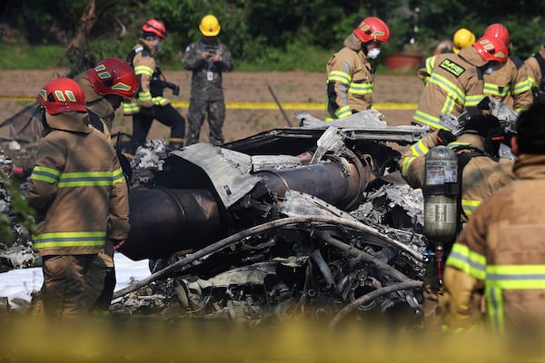 South Korean firefighters and military officers work at the scene of a South Korean navy plane's crash in Pohang, South Korea, Thursday, May 29, 2025. (Lee Mu-yeul/Newsis via AP)