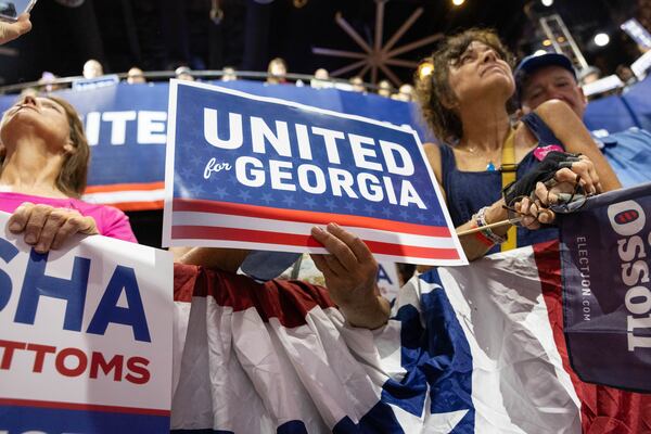 People cheer while listening to speakers during a rally with U.S. Sen. Jon Ossoff and Democratic nominee for governor Keisha Lance Bottoms in Athens on Sunday. (Felix Scheyer for the AJC)