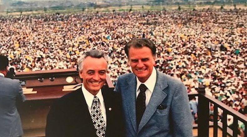 The Rev. Henry Holley of Marietta (left) whose early life was shaped by his time in the U.S. Marine Corps, became a key organizer for the Rev. Billy Graham’s national and international events. Here, he stands with Graham in front of the 1.1 million crowd in Seoul, South Korea, during one of Graham’s meetings. Courtesy of the family