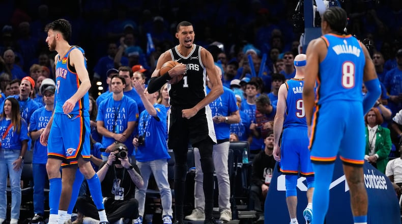 San Antonio Spurs forward Victor Wembanyama (1) celebrates after a dunk during the second overtime of Game 1 in a third-round NBA basketball playoffs series against the Oklahoma City Thunder Monday, May 18, 2026, in Oklahoma City. (AP Photo/Tony Gutierrez)