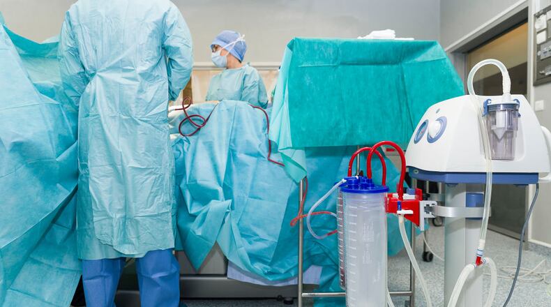 Doctors perform a weight loss surgery on a patient.