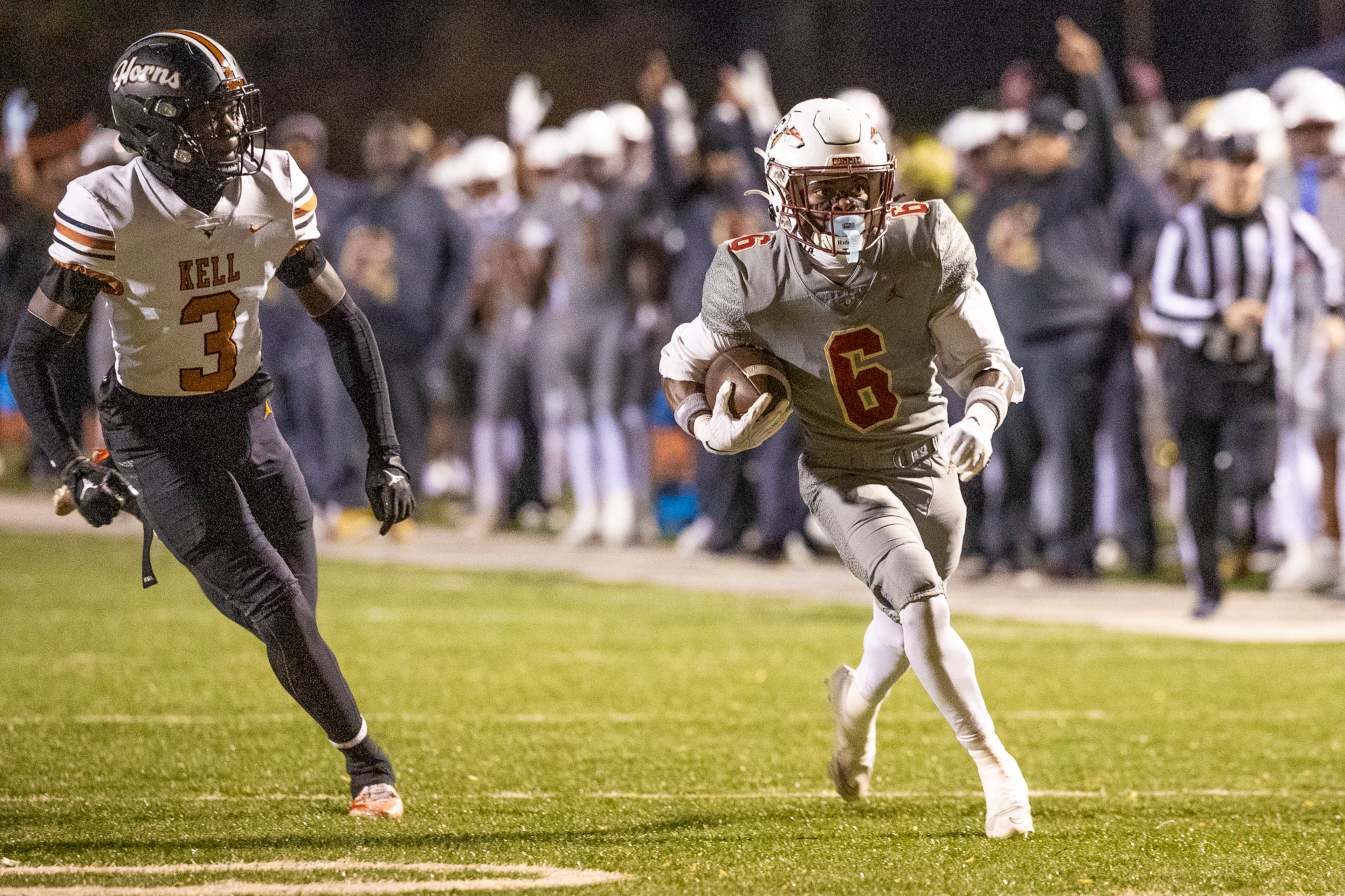 Creekside wide receiver Eric Paul Jr. (6) runs alongside Kell defensive back Tony Forney Jr. (3) during the first half of the class 4A semifinal against Kell at Creekside High School in Fairburn, GA on Friday, December 5, 2025. (Oscar Guevara Saenz for the AJC)