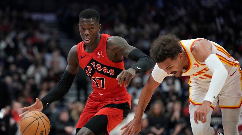 Toronto Raptors guard Dennis Schroder (17), a former Hawks player, dribbles the ball up court against Hawks guard Trae Young (11). (Frank Gunn/The Canadian Press via AP)