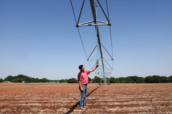 Lee Nunn shows an irrigation system for his cotton field in Morgan County on April 23, 2026.  (Arvin Temkar/AJC)