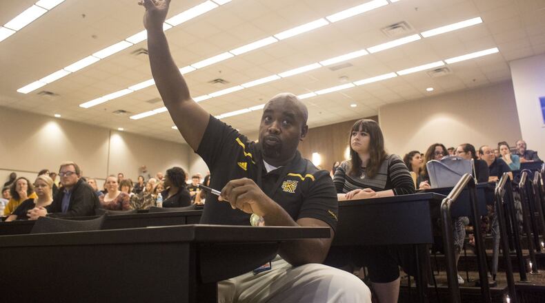 Omari Hodge, a staff member at Kennesaw State University who works in the health clinic, asks a question about House Bill 280, the “campus-carry” bill, on June 22, 2017. Chad Rhym/ Chad.Rhym@ajc.com