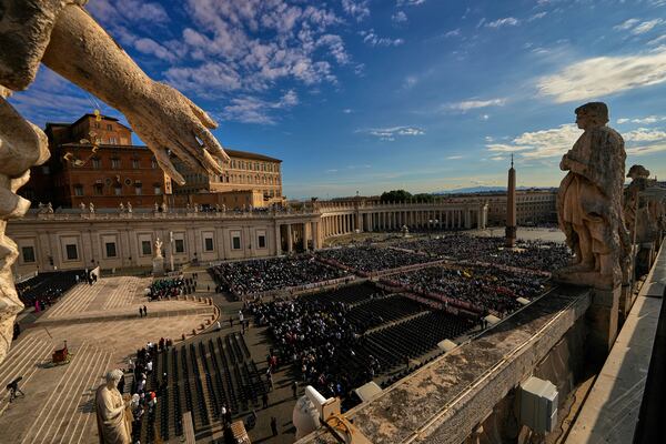 People start gathering ahead of a mass presided over by Vatican Secretary of State, Cardinal Pietro Parolin on the second of nine days of mourning for late Pope Francis in St. Peter's Square, at the Vatican, Sunday, April 27, 2025. (AP Photo/Andreea Alexandru)