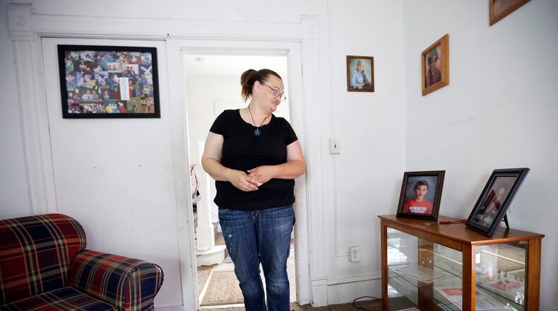 Tamara Bloemendaal looks at a photo of her son, Senquez Jackson, in Cedar Rapids, Iowa, on June 21, 2016. The 15-year old was killed earlier in the year when a gun a friend was playing with accidentally discharged. Jolted awake by her older son, she recalls helping Senquez out of the recliner and watching him collapse on the floor in a pool of blood. She rode in the ambulance with the boy she called “Chunks” as a baby. Within hours, he was dead. (AP Photo/Charlie Neibergall)