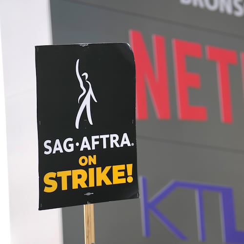 FILE - A picketer carries a sign on the picket line outside Netflix on Wednesday, Sept. 27, 2023, in Los Angeles. (AP Photo/Chris Pizzello, File)