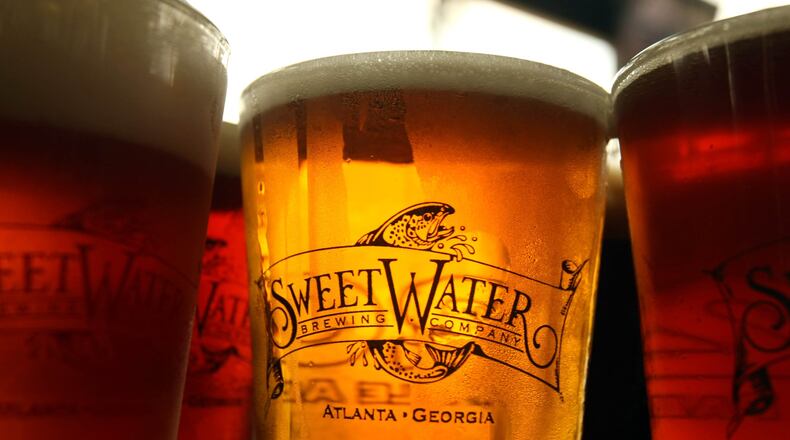 Atlanta-brewed SweetWater 420 (center) is one of the craft beers offered by Delta Air Lines. credit: Jason Getz / AJC file