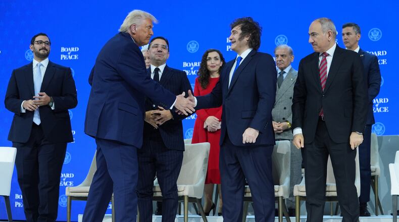 FILE - President Donald Trump, center left, shakes hands with Javier Milei, President of Argentina, during the Annual Meeting of the World Economic Forum in Davos, Switzerland, Thursday, Jan. 22, 2026. (AP Photo/Evan Vucci,File)