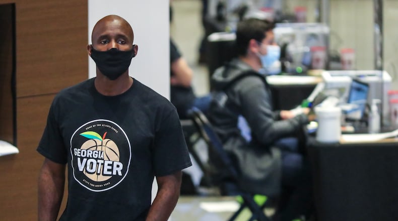Atlanta Hawks coach Lloyd Pierce was a poll volunteer on Monday, Oct. 12, 2020, - the first day of early voting - at State Farm Arena in downtown Atlanta.