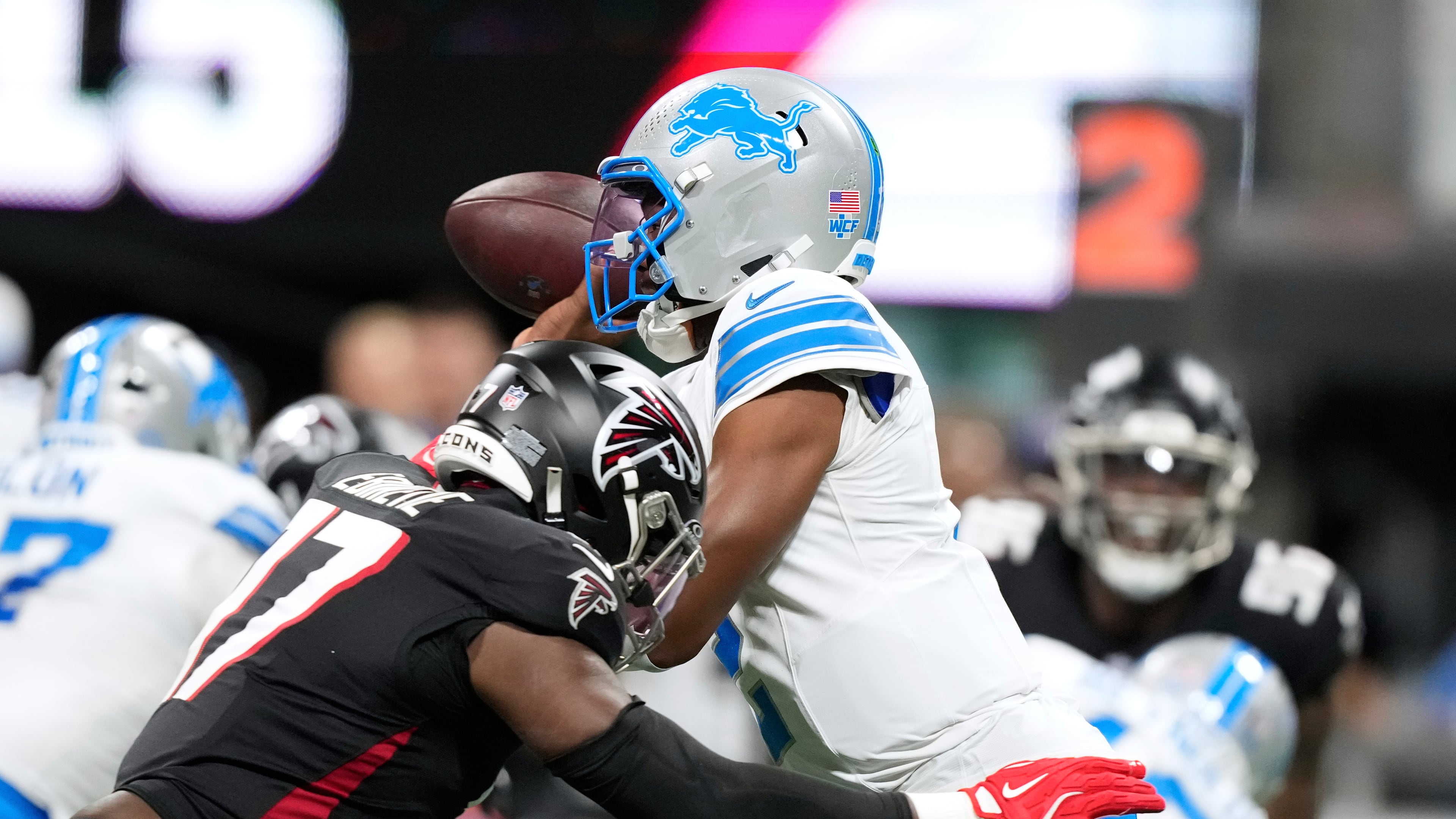 Lions quarterback Hendon Hooker (right) throws under pressure from Falcons linebacker Arnold Ebiketie during the first half on Friday, Aug. 8, 2025, in Atlanta. The game was later suspended. (Brynn Anderson/AP)