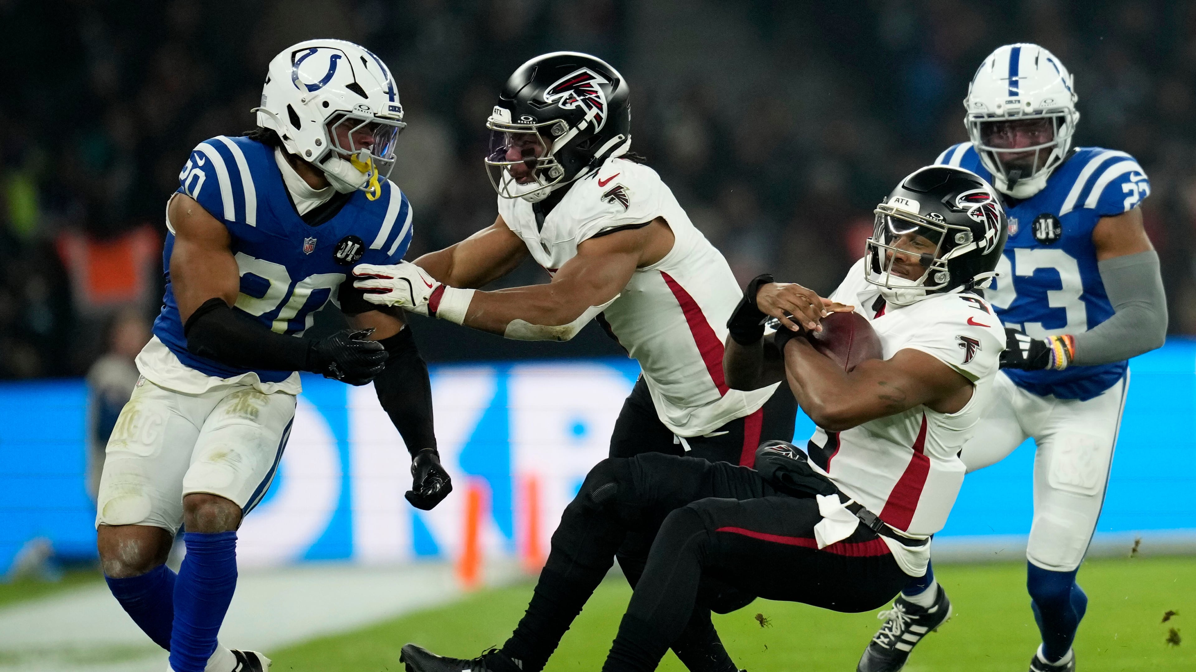 Atlanta Falcons quarterback Michael Penix Jr. (9) falls to the turf in front of Indianapolis Colts safety Nick Cross (20) during the first half of an NFL football game, Sunday, Nov. 9, 2025, in Berlin, Germany. (AP Photo/Ebrahim Noorozi)