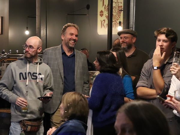 Democrat Eric Gisler (in sport coat) talked to supporters at an Athens pub about his election victory on Tuesday. (AP)