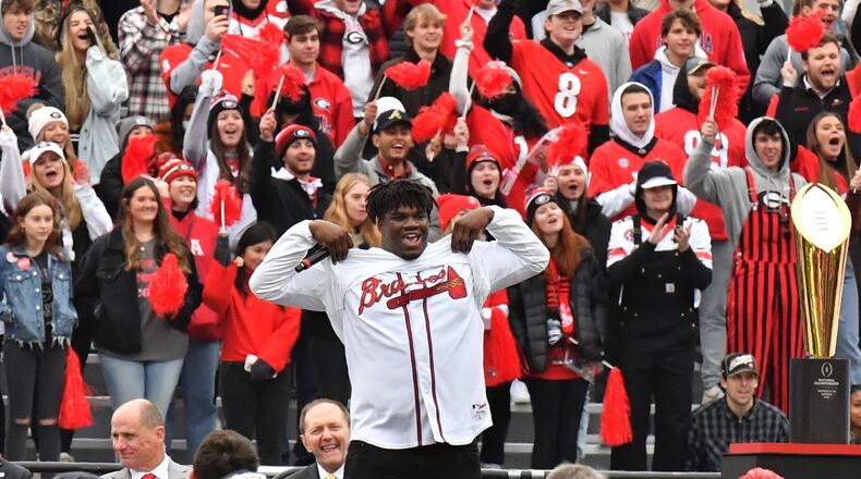 University of Georgia defensive lineman Jordan Davis displays his Atlanta Braves jersey, which was hidden under his UGA jersey, as he speaks during a celebration Jan. 15 at Sanford Stadium in Athens to mark Georgia’s College Football Playoff national championship. Georgia captured the national championship, its first since the 1980 season, with a 33-18 victory over Alabama at Lucas Oil Stadium in Indianapolis. The team then won another title this past January. (Hyosub Shin / Hyosub.Shin@ajc.com)