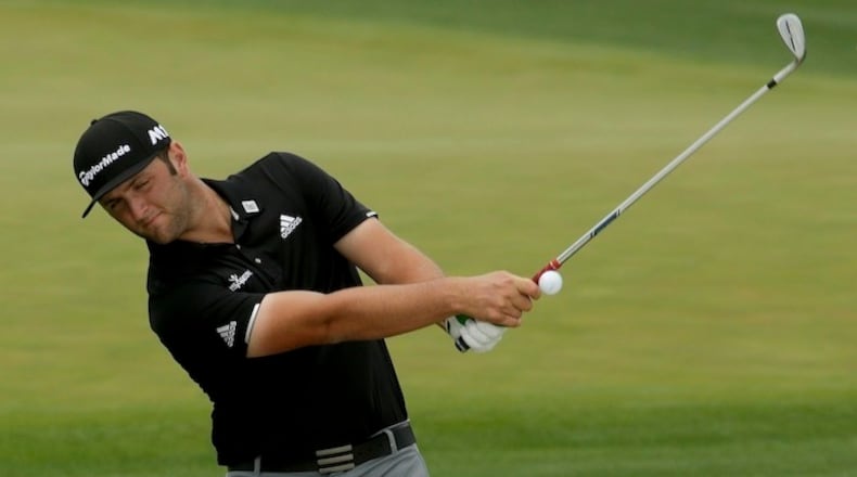 Jon Rahm, of Spain, hits out of the bunker on the driving range during practice for the Masters golf tournament Monday, April 3, 2017, in Augusta, Ga. (AP Photo/Charlie Riedel)